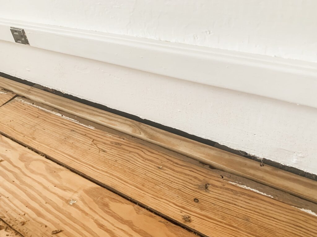 Sagging floor and cracked basement beam before repair